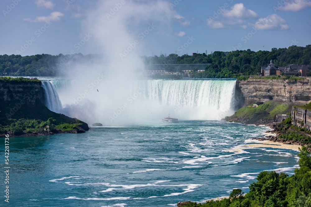 Beautiful shot of Niagara Falls under a blue cloudy sky on a sunny day Beautiful shot of Niagara Falls under a blue cloudy sky on a sunny day