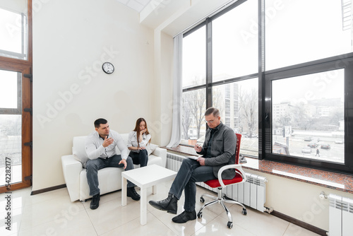 A young married couple came to an appointment and consultation with a psychotherapist. Counseling and help during depression and solving family problems.