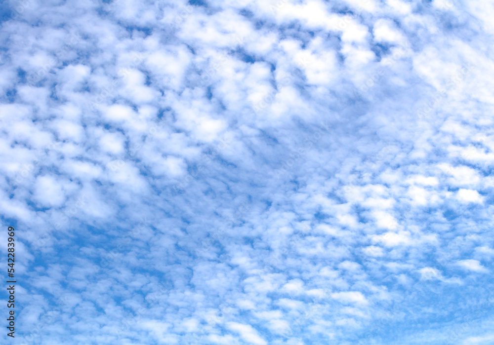 White cumulus clouds against blue sky. Atmospheric phenomena.	