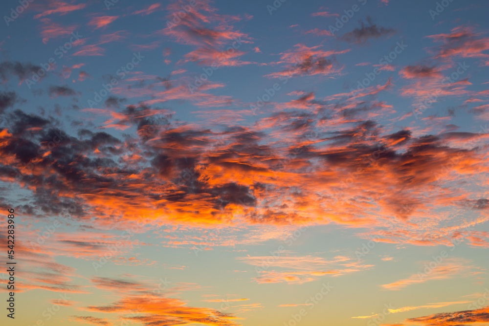 Fototapeta premium Beautiful sunset. Orange shades on clouds in evening. Natural phenomena. Spectacular atmospheric effects.