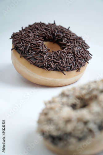 chocolate doughnut isolated on white background, with chocolate nut doghnut in foreground photo