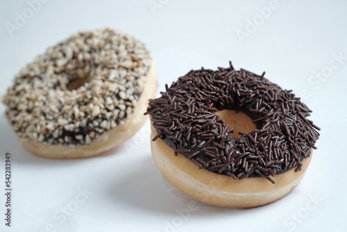 chocolate doughnut isolated on white background, with chocolate nut doghnut in background photo