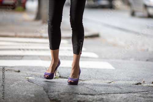 woman's legs with purple high heel shoes