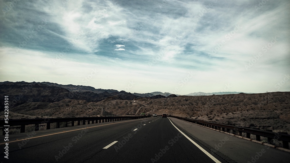 Beautiful shot of an empty road in the middle of Nevada landscapes Beautiful shot of an empty road in the middle of Nevada landscapes