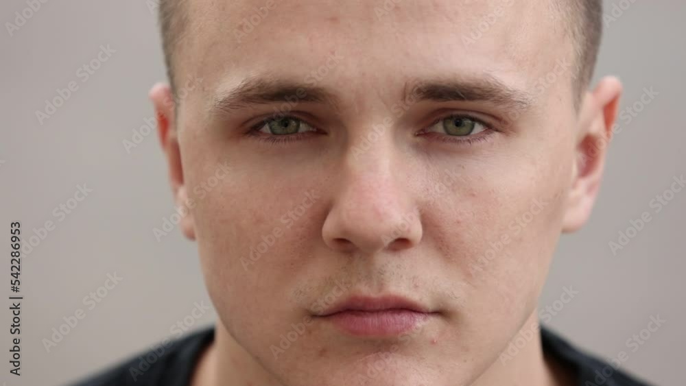 concentrated handsome young man with brown eyes and healthy skin looking to camera concentrated handsome young man with brown eyes and healthy skin looking to camera