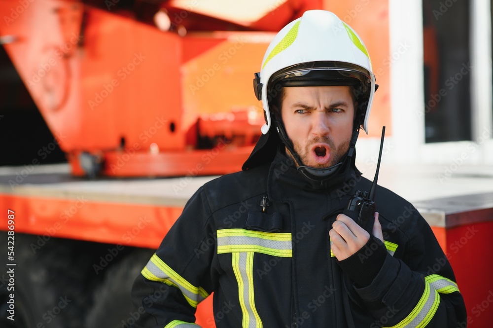 Obraz premium Photo of fireman with gas mask and helmet near fire engine
