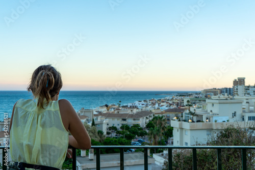 Girl enjoying sunset over sea in Torremolinos, Spain on September 04, 2022