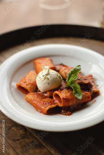 Appetizing Italian pasta with cheese on a dark wooden background