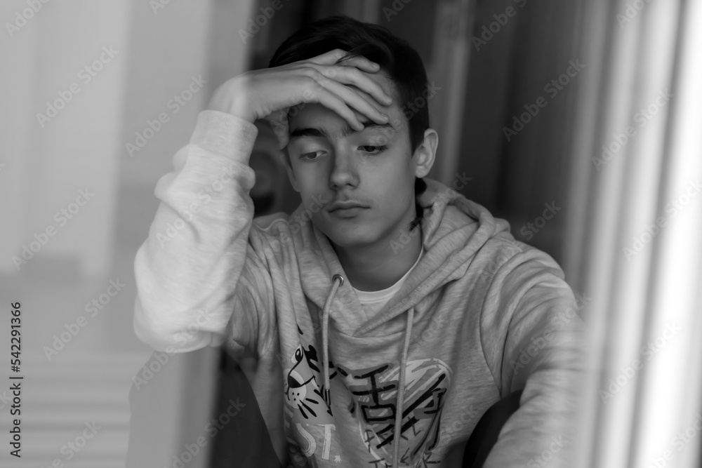 portrait of teenage boy in black and white portrait of teenage boy in black and white