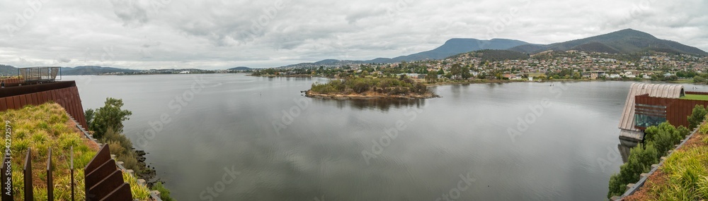 Panoramic View Of Hobart city houses by water in Australia under blue sky