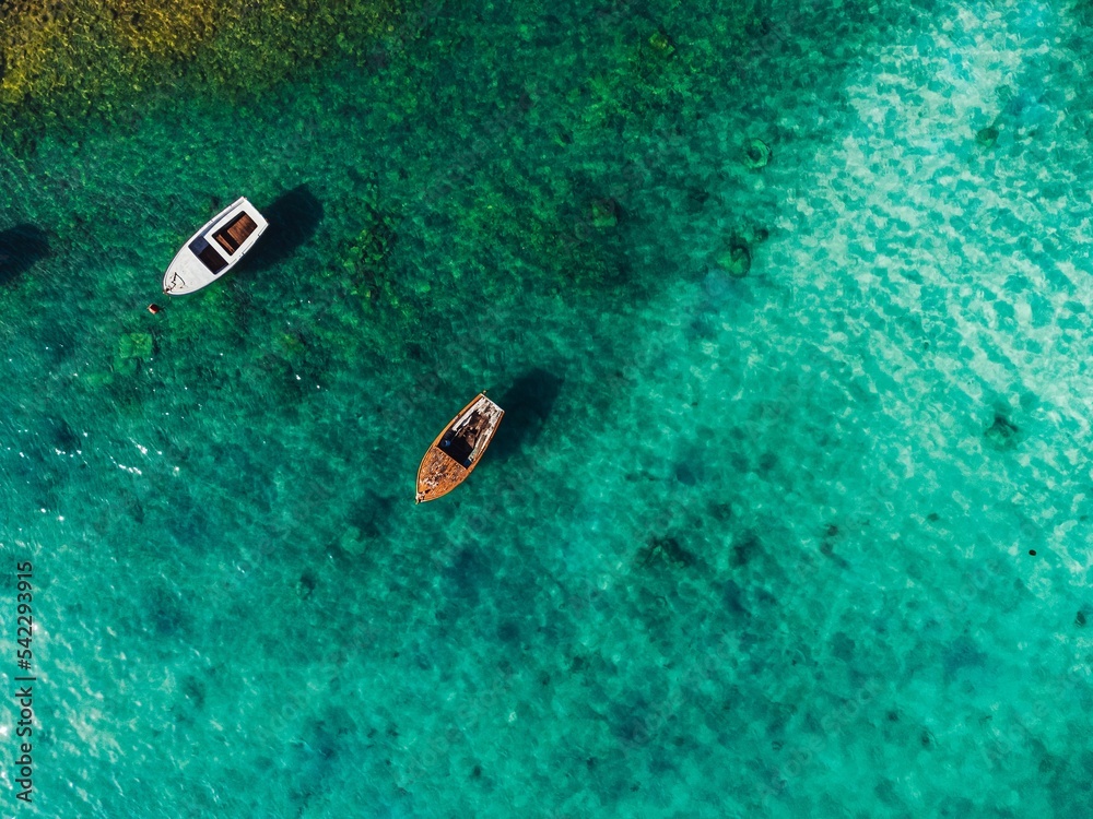 Calming aerial view of two boats in the azure sea in Croatia Calming aerial view of two boats in the azure sea in Croatia