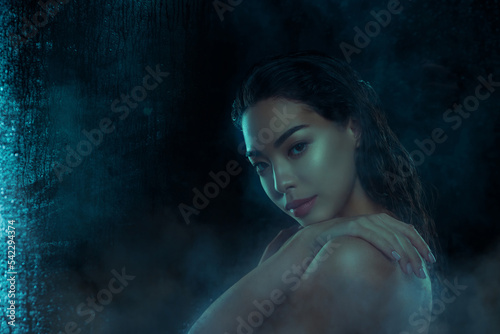 Photo of stunning lady touching hands doing washing at night isolated on dark wet humid glass background