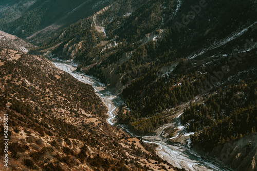 View of green forest meets brown  bushes with Khangsar river in the middle, from the way to Tilicho Base Camp, Annapurna Circuit Trek, Nepal photo
