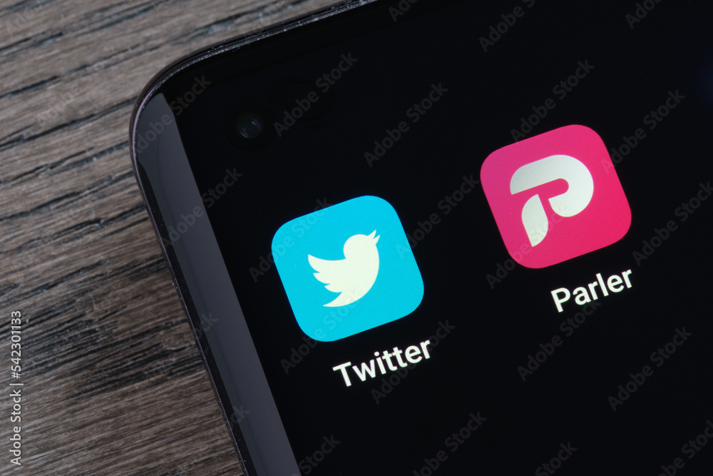 Twitter and Parler apps seen on the screen of smartphone. Concept for