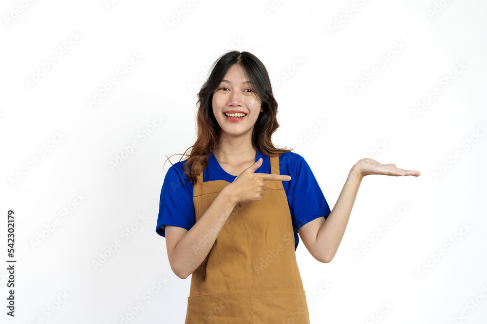 Palm up, Cheerful young pretty asian woman blue t-shirt and apron coffee owner isolated on white background. Palm up, Cheerful young pretty asian woman blue t-shirt and apron coffee owner isolated on white background.