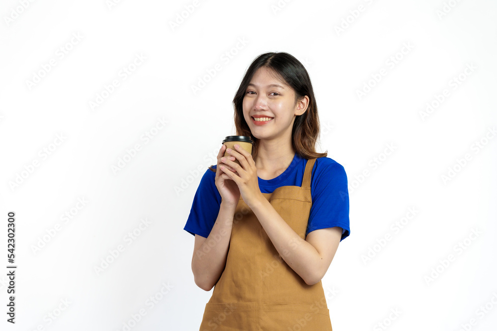 Cheerful young pretty asian woman blue t-shirt and apron coffee owner isolated on white background. Holding paper coffee cup Cheerful young pretty asian woman blue t-shirt and apron coffee owner isolated on white background. Holding paper coffee cup