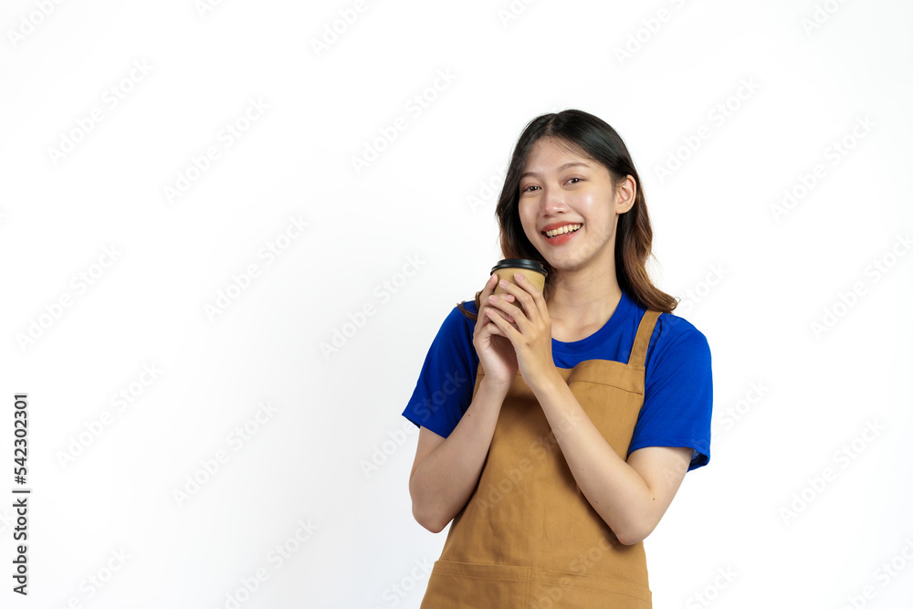 Cheerful young pretty asian woman blue t-shirt and apron coffee owner isolated on white background. Holding paper coffee cup Cheerful young pretty asian woman blue t-shirt and apron coffee owner isolated on white background. Holding paper coffee cup