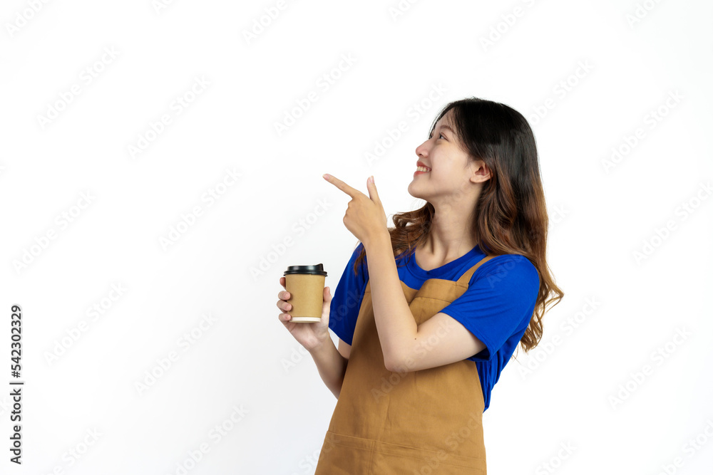 Cheerful young pretty asian woman blue t-shirt and apron coffee owner isolated on white background. Holding paper coffee cup Cheerful young pretty asian woman blue t-shirt and apron coffee owner isolated on white background. Holding paper coffee cup