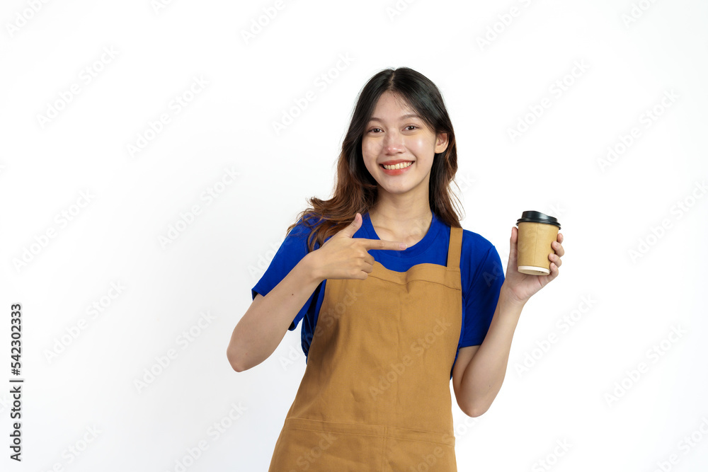 Cheerful young pretty asian woman blue t-shirt and apron coffee owner isolated on white background. Holding paper coffee cup Cheerful young pretty asian woman blue t-shirt and apron coffee owner isolated on white background. Holding paper coffee cup