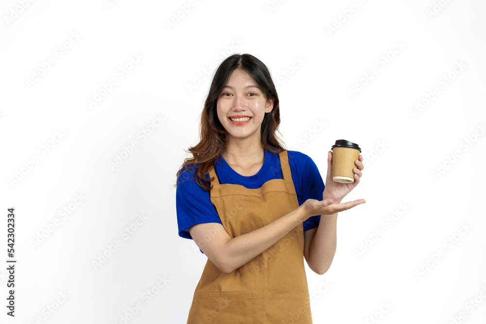 Cheerful young pretty asian woman blue t-shirt and apron coffee owner isolated on white background. Holding paper coffee cup Cheerful young pretty asian woman blue t-shirt and apron coffee owner isolated on white background. Holding paper coffee cup