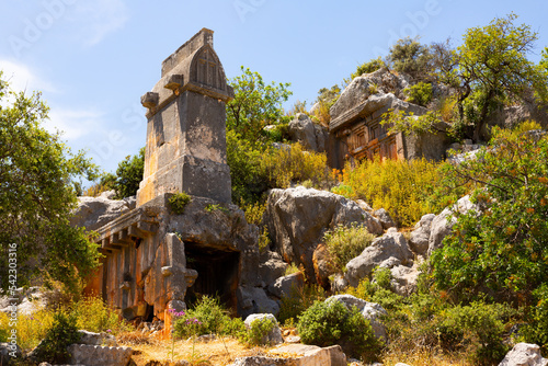 Fotografia Rock tombs, tombstones and sarcophagi on a mountainside near the ancient city of Sura