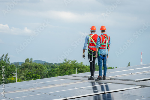 Technician inspection and repair solar cell on the roof of factory,Solar PV Rooftop.