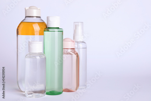 Bottles of micellar water on white background. Space for text