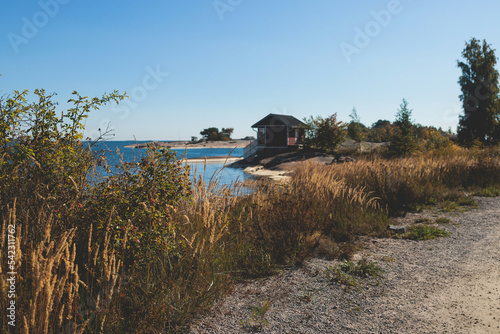 View of Hanko town coast, Hango, Finland, with beach and coastal waterfront, wooden houses and beach changing cabins, Uusimaa, Hanko Peninsula, Raseborg sub-region, summer sunny day photo