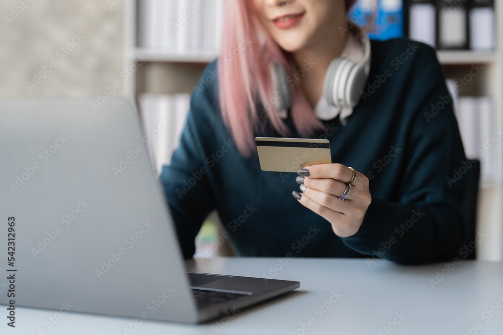 Young person using credit card and laptop computer. Online shopping, e-commerce concept Young person using credit card and laptop computer. Online shopping, e-commerce concept