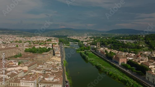 Aerial view of Arno river and historic buildings along. Terzo Giardino park on waterfront and old stone Porta San Niccolo tower. Florence, Italy photo