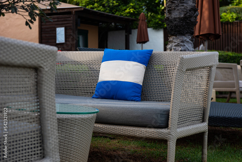 Blue pillow on a comfortable long chair and a relaxing seating set on the beach. © athichoke.pim