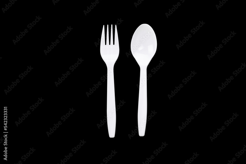 White plastic spoon and fork isolated on black background with clipping path. White plastic spoon and fork isolated on black background with clipping path.