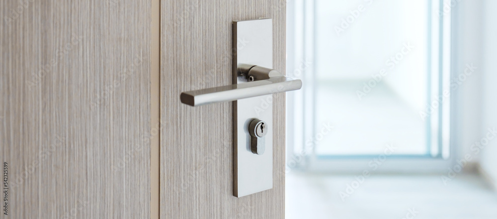 Closeup doorknob of wooden door between open or close the door Closeup doorknob of wooden door between open or close the door