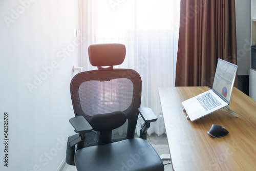 Ergonomic chair and Adjustable table with laptop computer in modern workplace. Good posture to avoid Office syndrome, Back Pain, shoulder ache, fibromyalgia and Neck pain © Jo Panuwat D