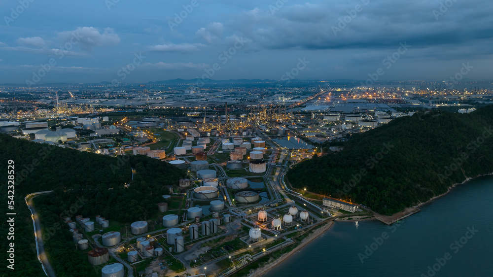 Oil refinery plant from industry zone, petrochemical industrial, Refinery factory and oil storage tank  pipeline at twilight aerial view