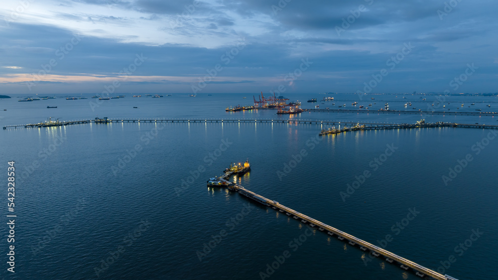 Aerial seascape view and Oil and gas pipeline bridge stretched through the sea at twilight .