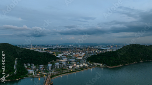 Oil refinery plant from industry zone, petrochemical industrial, Refinery factory and oil storage tank  pipeline at twilight aerial view © SHUTTER DIN