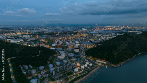 Oil refinery plant from industry zone  petrochemical industrial  Refinery factory and oil storage tank  pipeline at twilight aerial view
