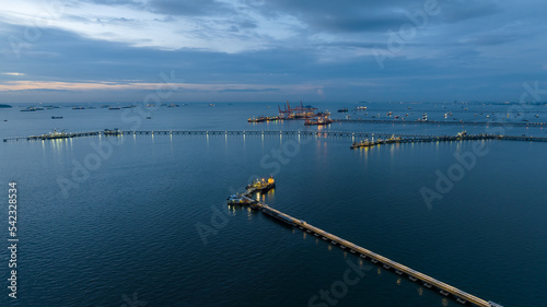 Aerial seascape view and Oil and gas pipeline bridge stretched through the sea at twilight .