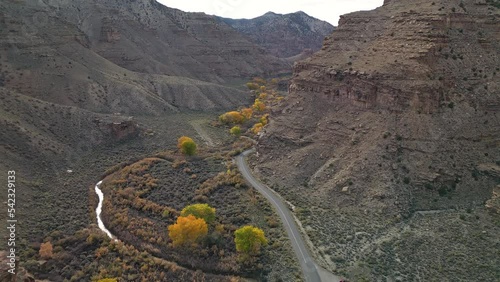 Aerial view of road through Nine Mile Canyon during Fall in Utah slowly moving through the canyon. photo