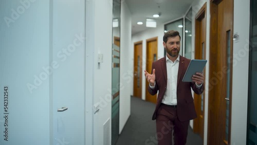 Wallpaper Mural Bearded chief having video call at office closeup. Employee using pad in hall Torontodigital.ca