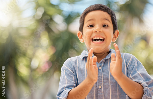 Happy, wow and boy clapping hands in in a park, excited and surprised by good news, nature and learning. Portrait, child and hands by kid face in shock, happiness and celebrating fun in a forest