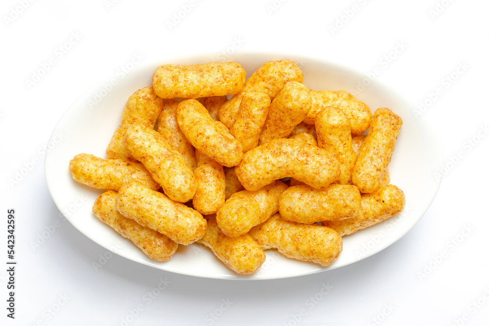 Peanut flips, in a white bowl. Also known as Bamba, peanut puffs or snips, is a puffed, peanut-flavored corn snack, with a peanut content up to a third. Close-up, from above, macro food photo. Peanut flips, in a white bowl. Also known as Bamba, peanut puffs or snips, is a puffed, peanut-flavored corn snack, with a peanut content up to a third. Close-up, from above, macro food photo.