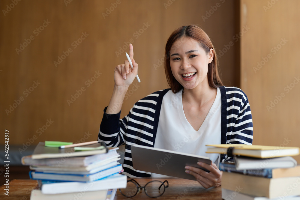 Smart asian young student having idea startup while reading a book. Smart asian young student having idea startup while reading a book.
