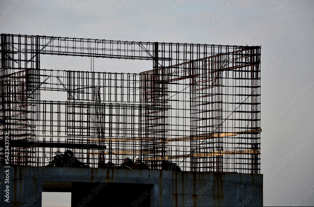 Obraz premium houses built of reinforced steel concrete are earthquake resistant and can be several stories high. wire mesh is braided and poured with concrete from the mixer, rusty, rust, stop, 