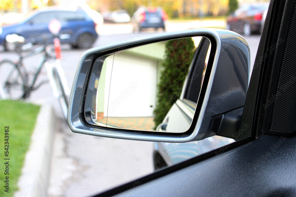 Rear view mirror with beautiful reflection. View from inside the car. Side rear-view mirror on a modern car. Close up rearview mirror lux car.