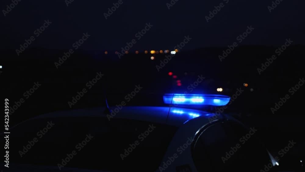 Nighttime police flasher closeup. Blue and red flashing lights on the