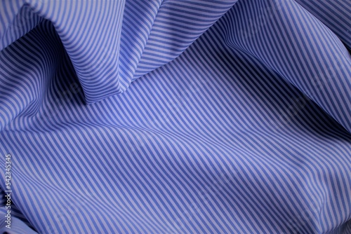 Blue and white striped fabric with pleats. Linen, silk or poplin.