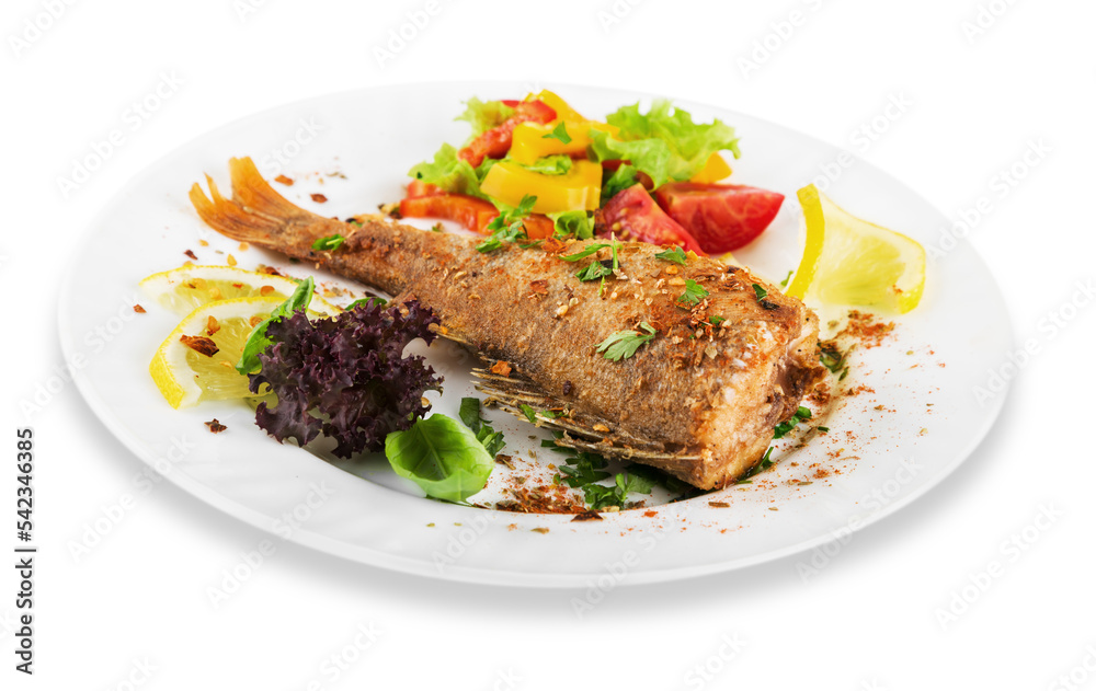 Grilled fish with vegetables on white plate Grilled fish with vegetables on white plate