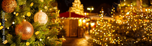 Christmas market at European town with christmas tree and lights, Evening time, blured, bokeh. Banner size. photo